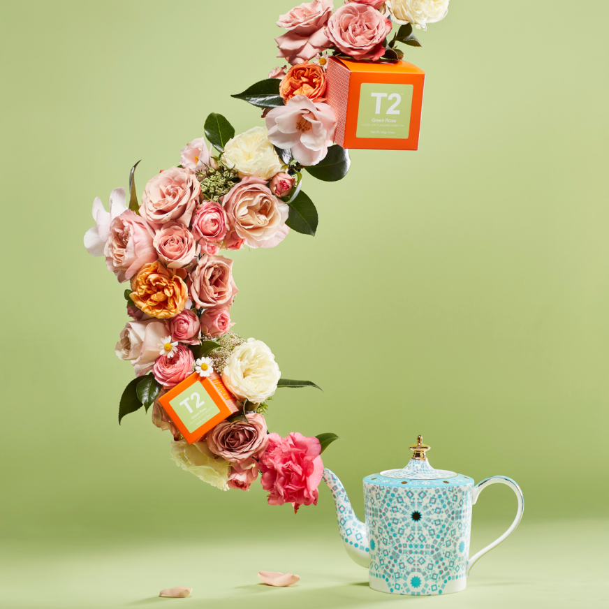 Flowers and Green Rose tea eminating from a teapot spout