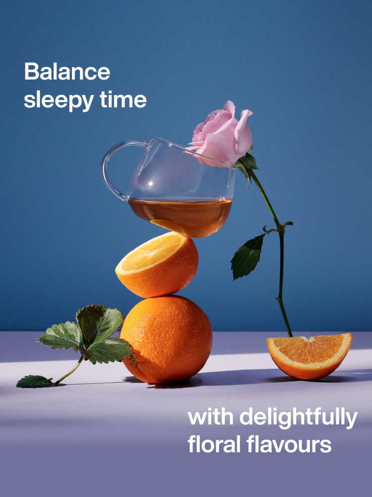 A cup of tea balanced on a stack of oranges