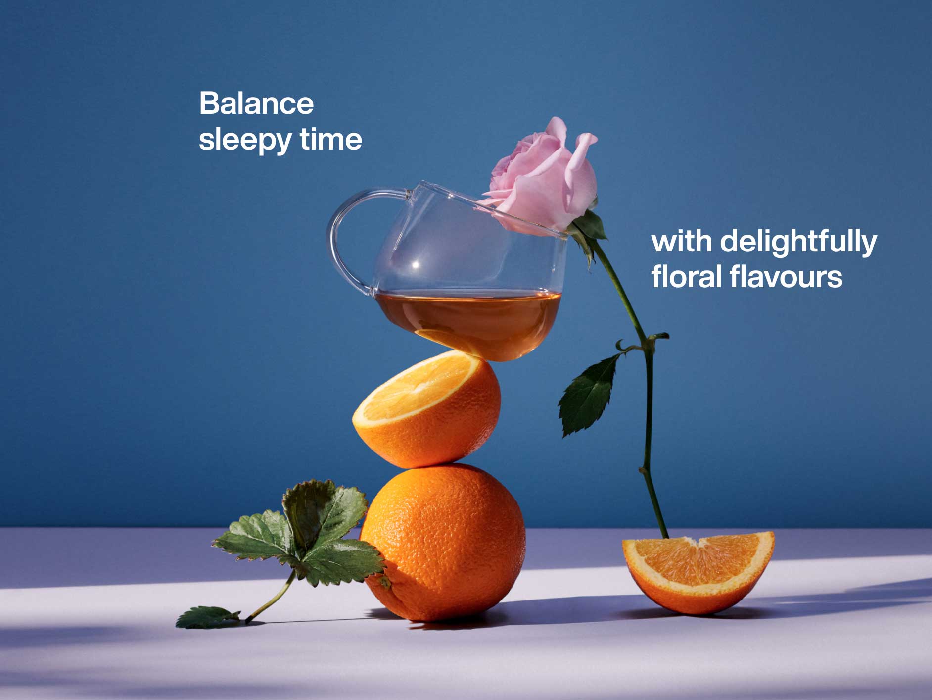 A cup of tea balanced on a stack of oranges