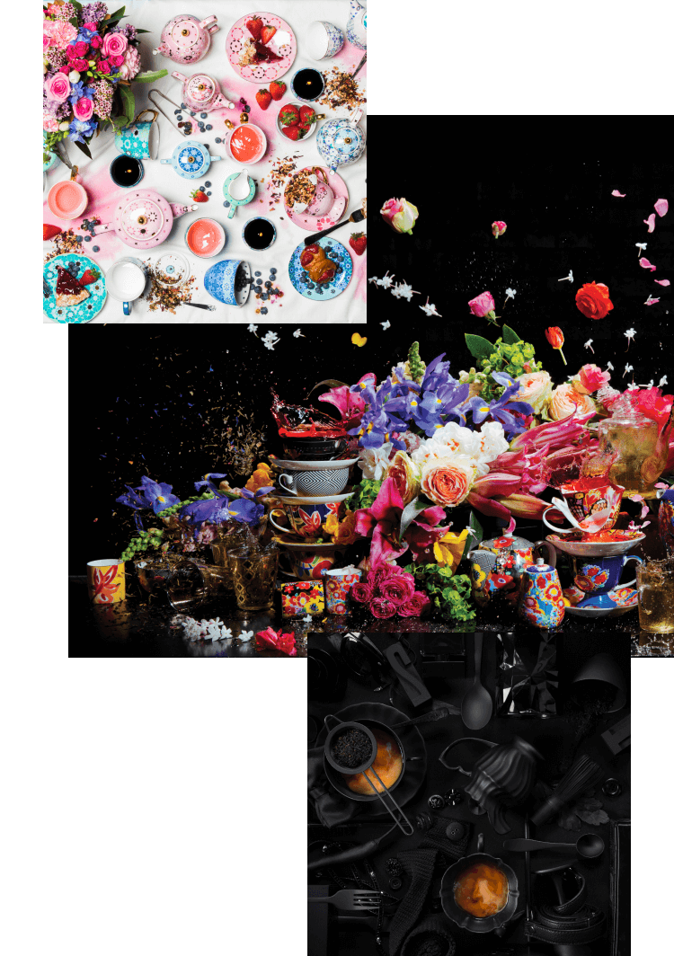 Colourful teapots with flowers and tea arranged sporadically on a table top