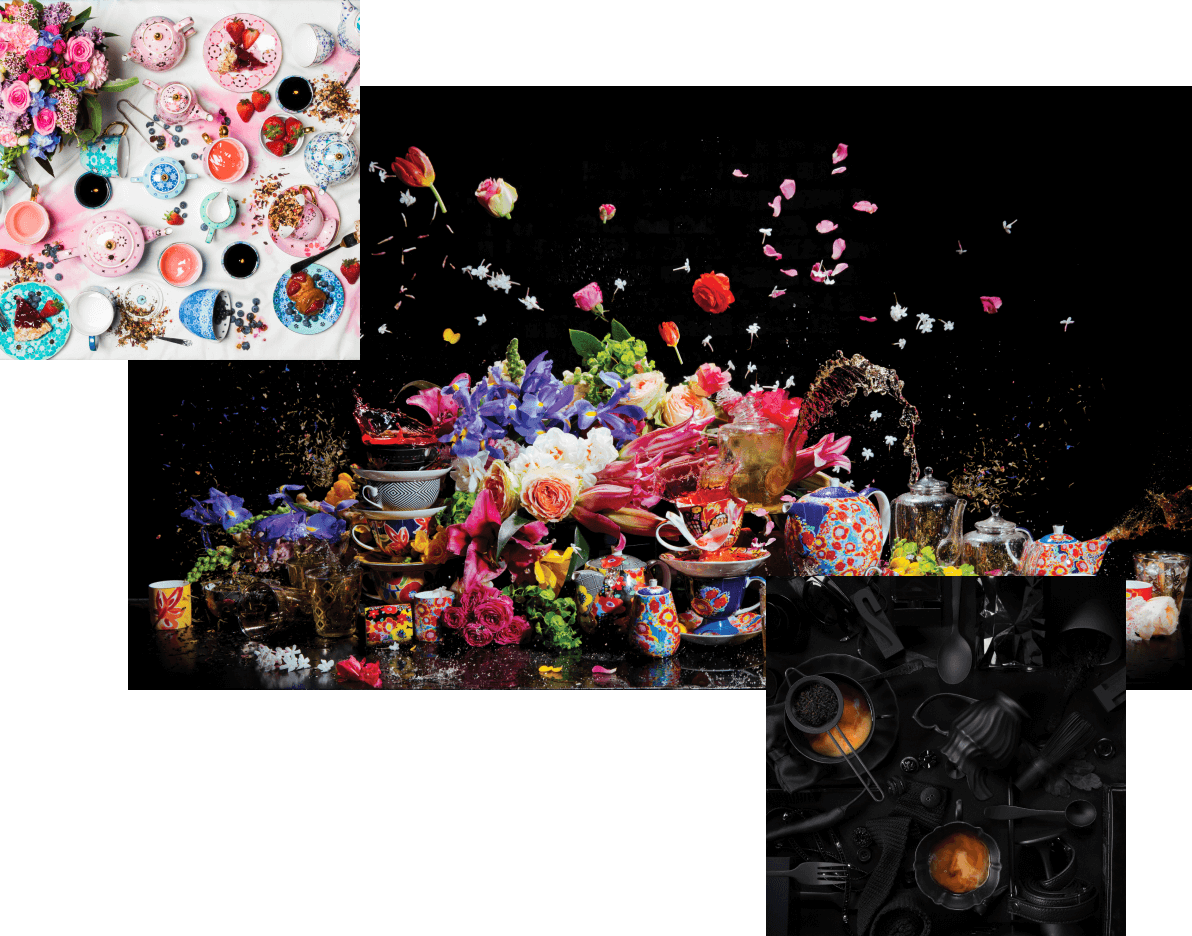 Colourful teapots with flowers and tea arranged sporadically on a table top