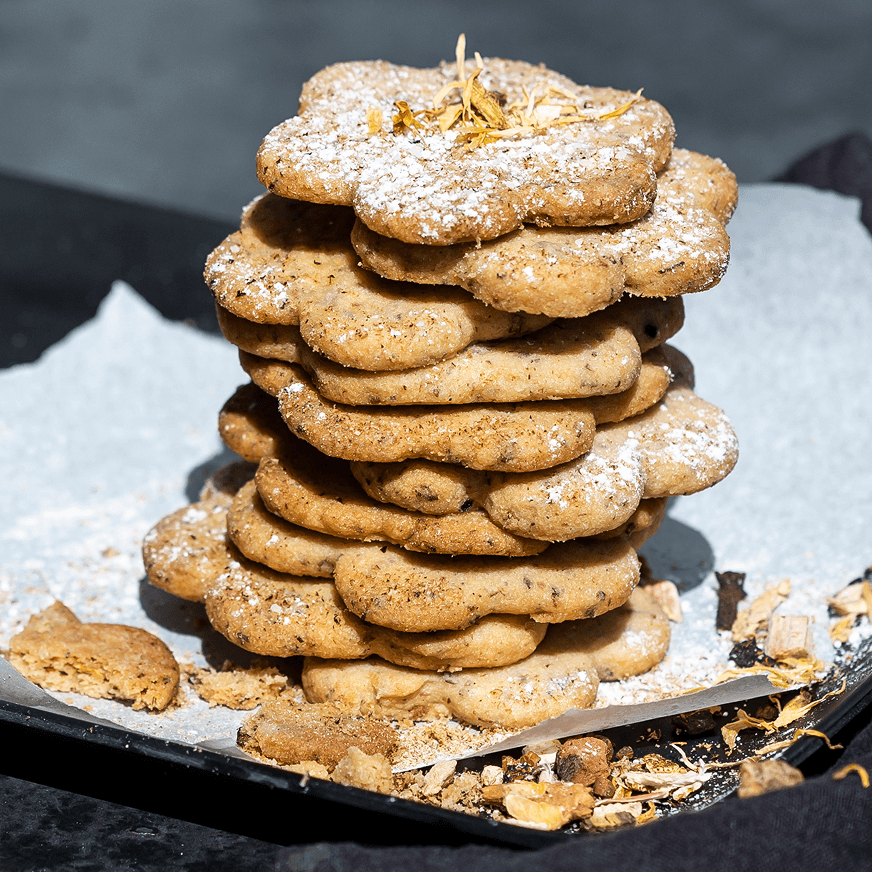 Chai spiced cookies stacked on a baking tray