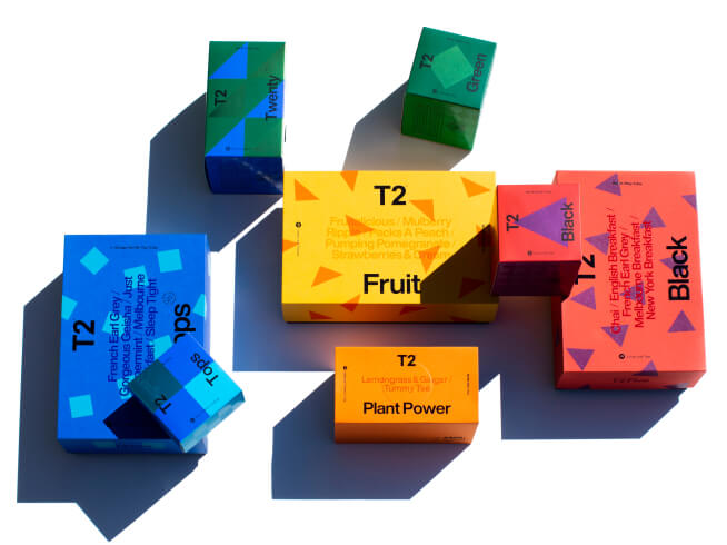 Boxes of T2 Tea gift packs scattered around