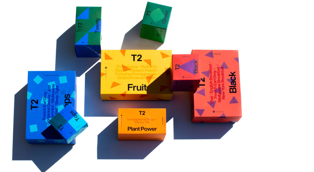 Boxes of T2 Tea gift packs scattered around