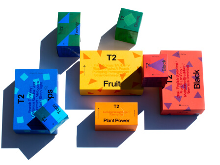 Boxes of T2 Tea gift packs scattered around