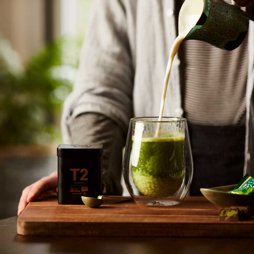 A cup of Matcha tea being poured